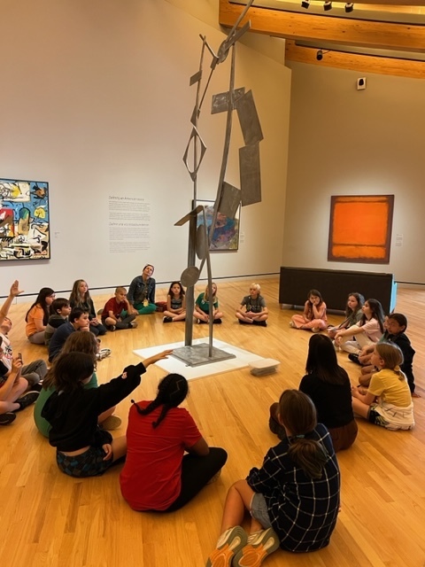 Students discuss angles at a David Smith sculpture